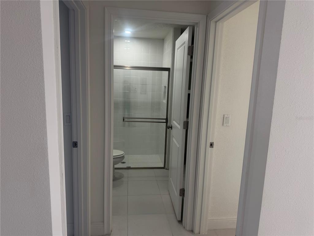 3444 Packard Avenue St. Cloud, FL 34772 - Photo 24 of 28 a bathroom with a glass shower door