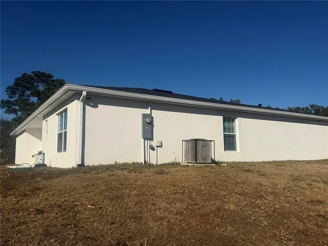 a very nice looking yard with a red chair