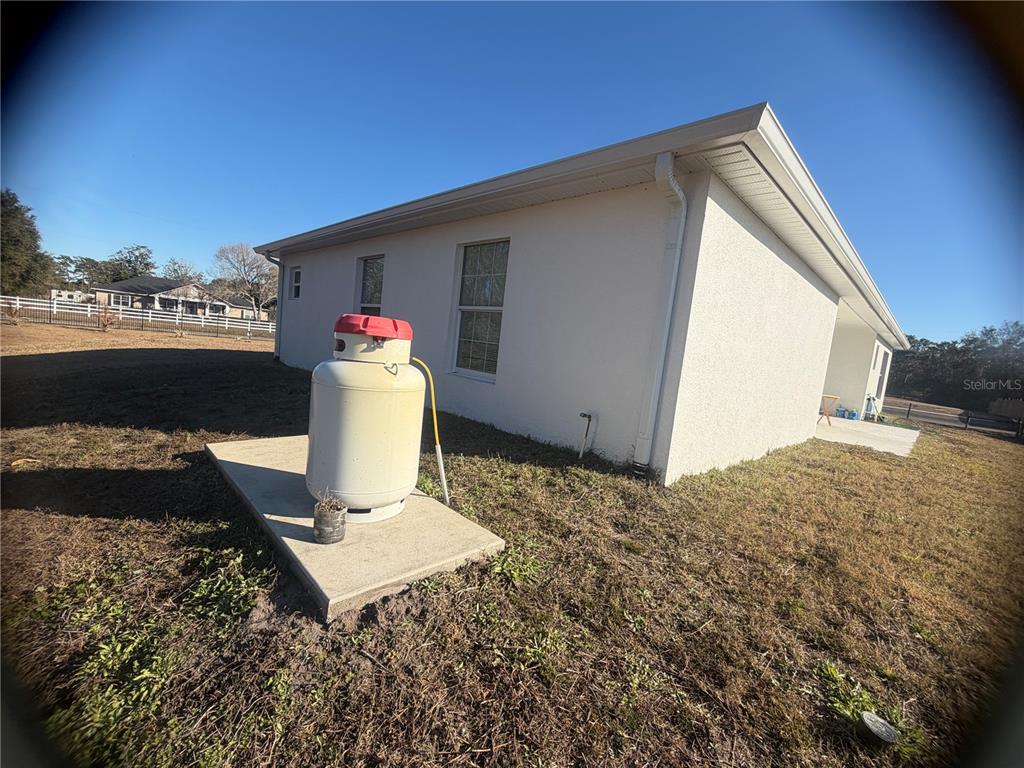 3444 Packard Avenue St. Cloud, FL 34772 - Photo 4 of 28 a very nice looking yard with a red chair