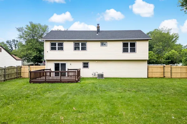 a view of a house with a yard and sitting area