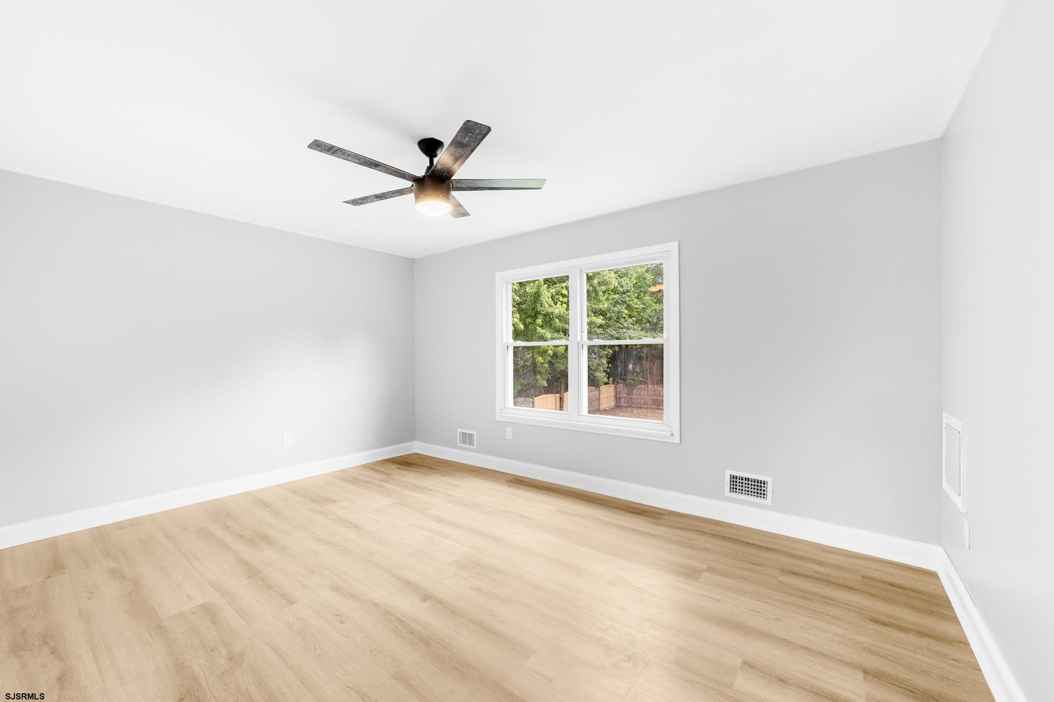 243 Wintergreen Lane Penns Grove, NJ 08069 - Photo 16 of 32 an empty room with a window and a ceiling fan