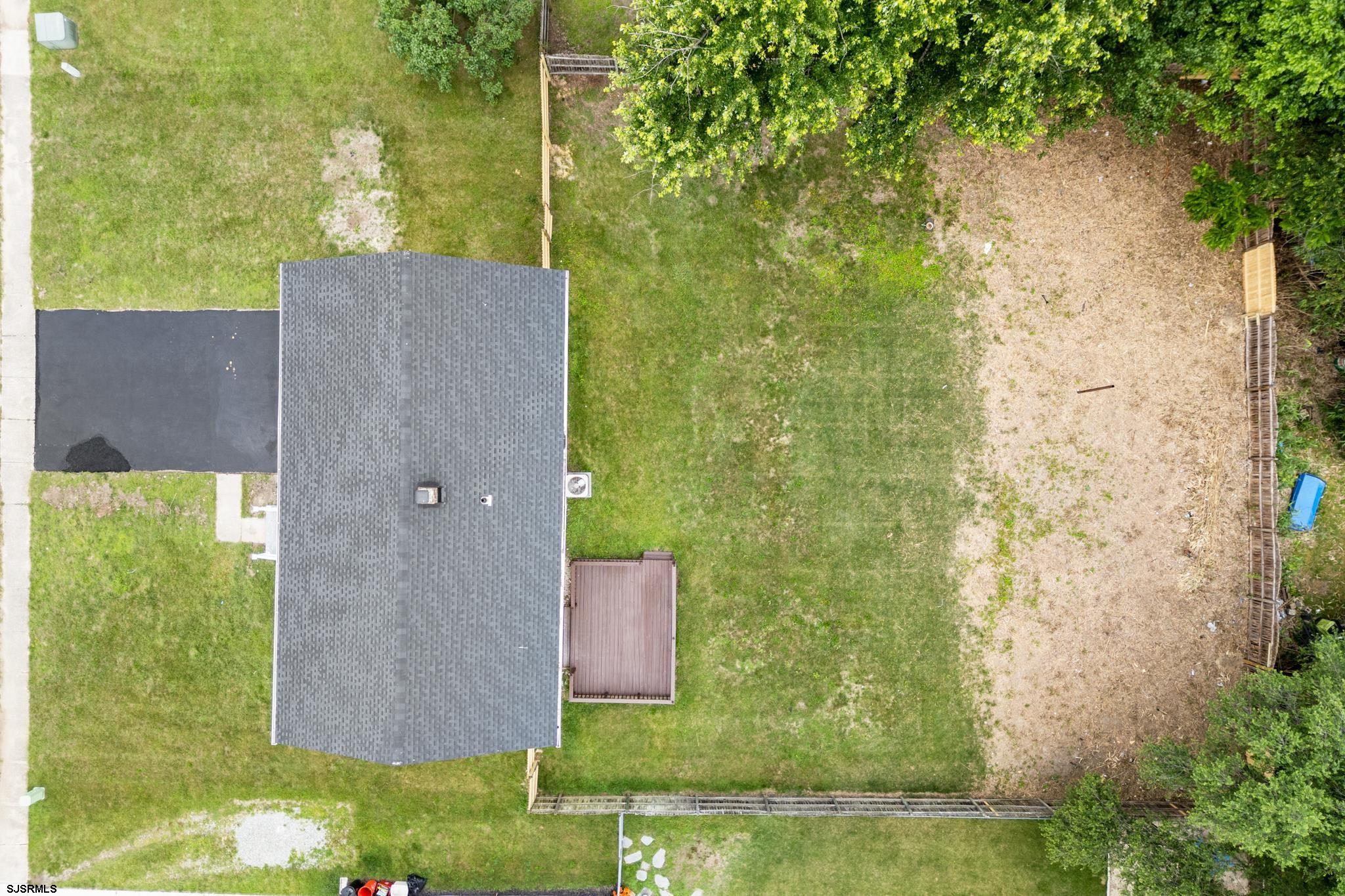 243 Wintergreen Lane Penns Grove, NJ 08069 - Photo 29 of 32 a brick house next to a yard with a tree