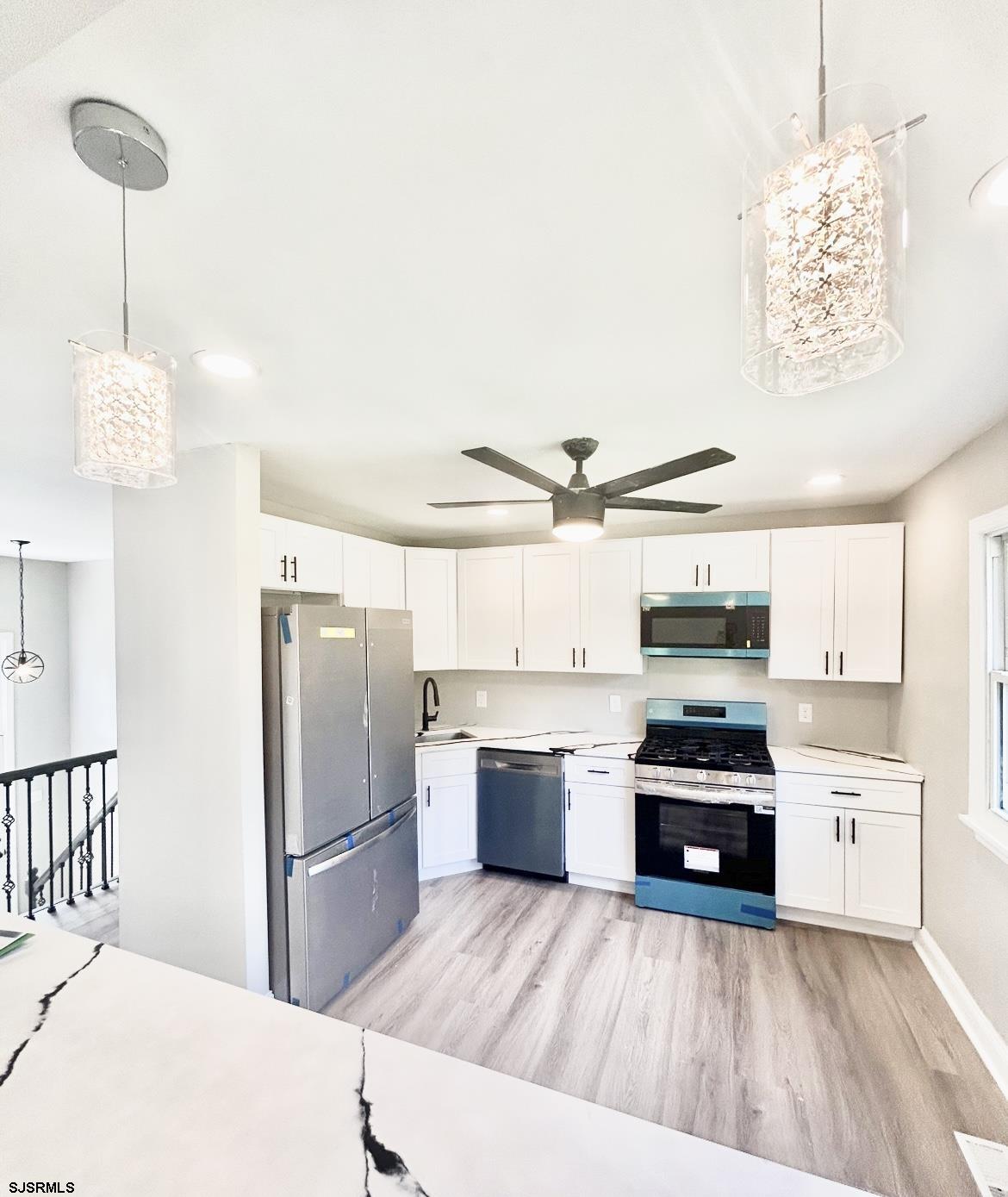243 Wintergreen Lane Penns Grove, NJ 08069 - Photo 7 of 32 a kitchen with stainless steel appliances a refrigerator sink and cabinets