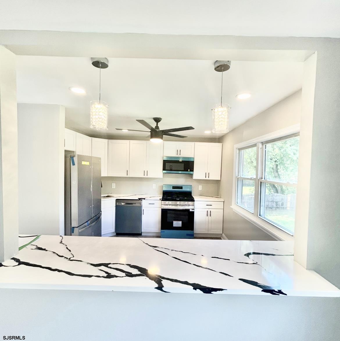 243 Wintergreen Lane Penns Grove, NJ 08069 - Photo 8 of 32 a kitchen with stainless steel appliances kitchen island granite countertop a sink and cabinets