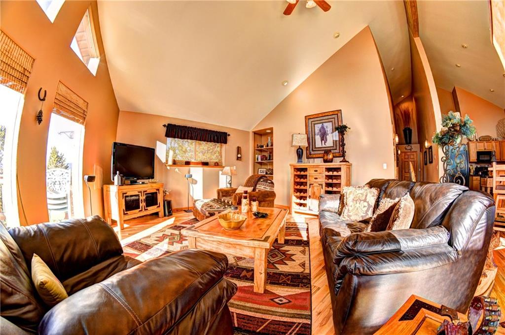 108 Australian Road Como, CO 80456 - Photo 12 of 25 a living room with furniture a flat screen tv and a floor to ceiling window