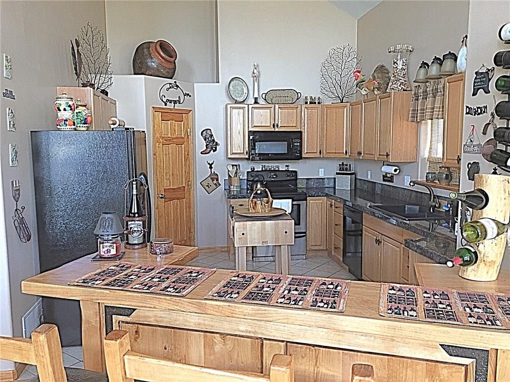 108 Australian Road Como, CO 80456 - Photo 4 of 25 a kitchen with stainless steel appliances granite countertop a sink stove and refrigerator
