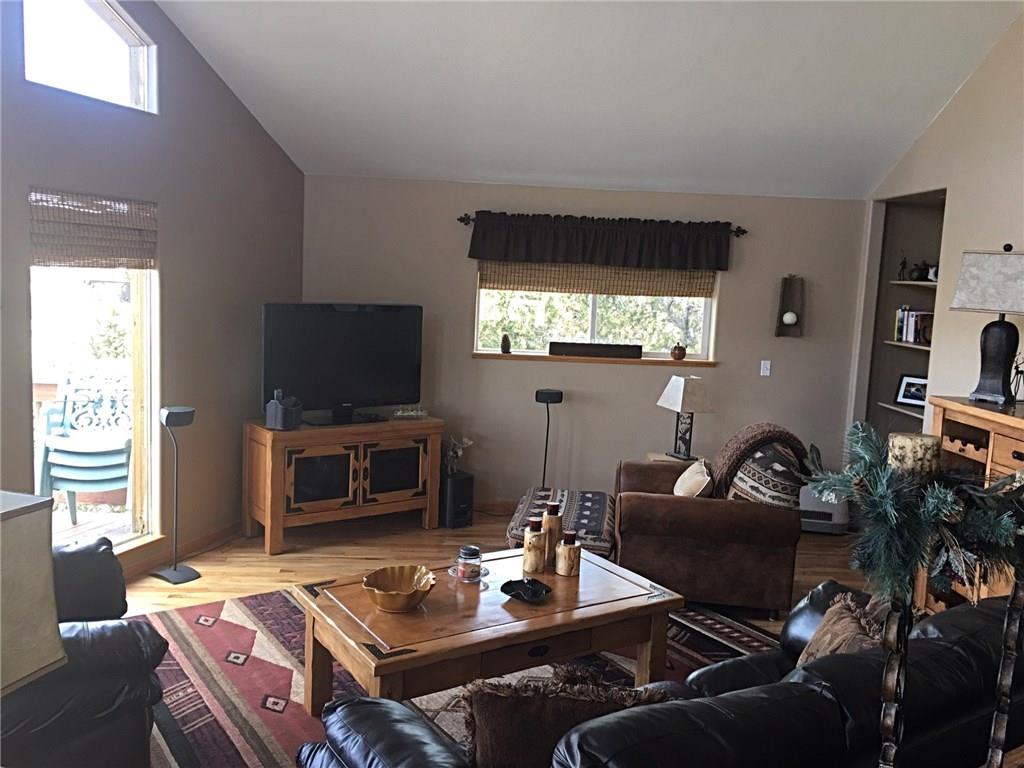108 Australian Road Como, CO 80456 - Photo 5 of 25 a living room with furniture a flat screen tv and a fireplace