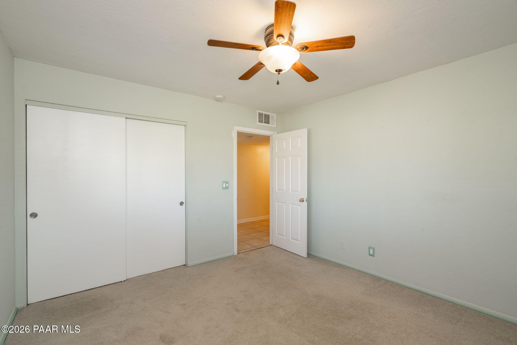 17270 East Peach Tree Road Mayer, AZ 86333 - Photo 15 of 31 an empty room with closet and a chandelier fan