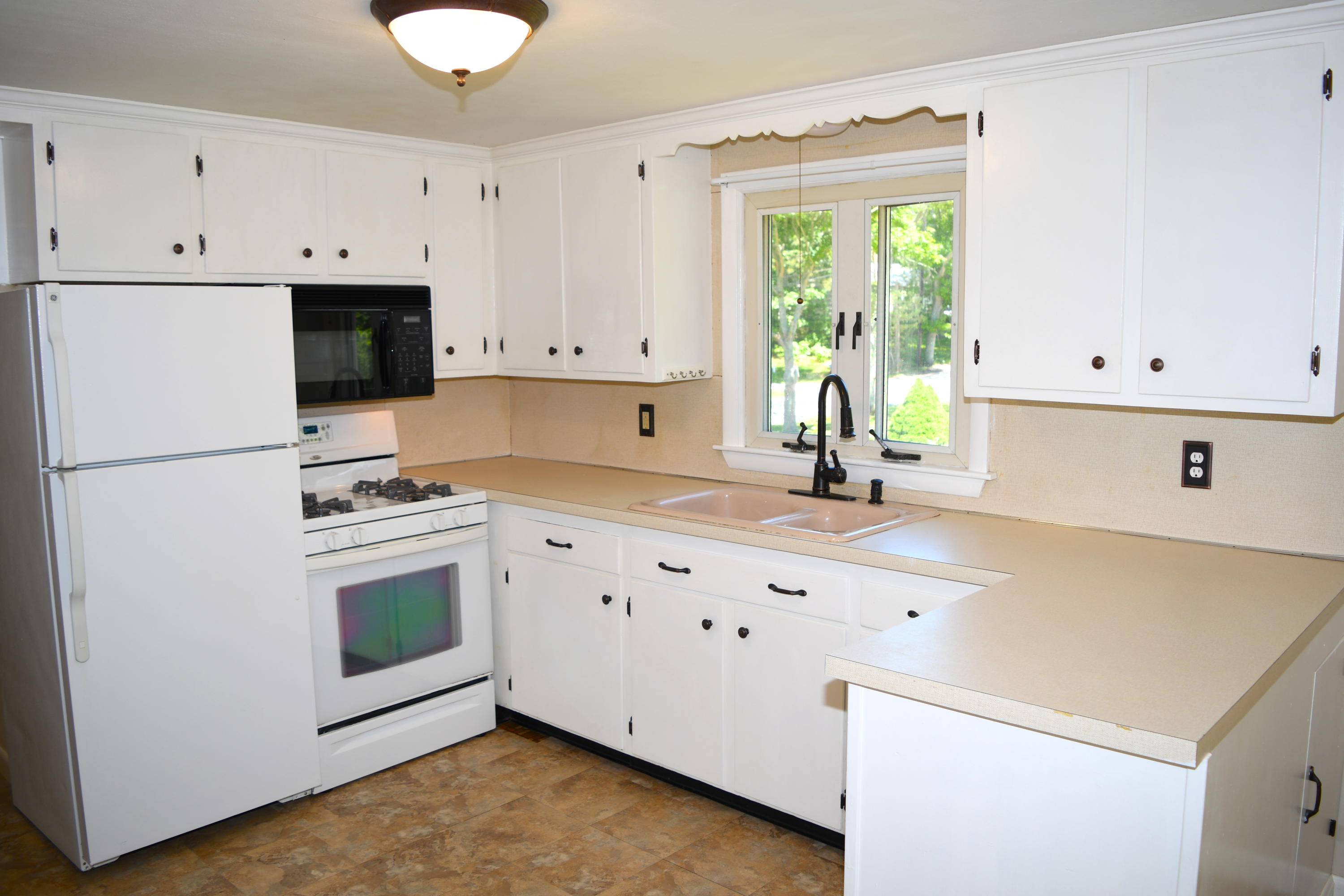 14 Marilyn Road Buzzards Bay, MA 02532 - Photo 11 of 20 a kitchen with granite countertop white cabinets and white appliances