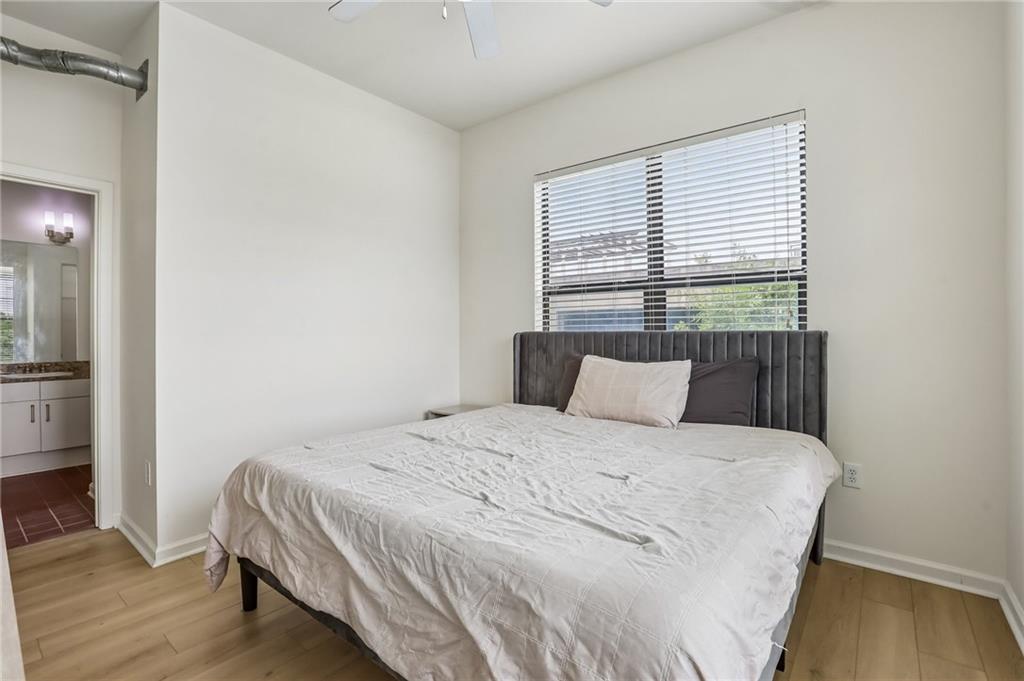 5300 Peachtree Road, Unit 3506 Atlanta, GA 30341 - Photo 9 of 25 a large bed sitting in a bedroom next to a window