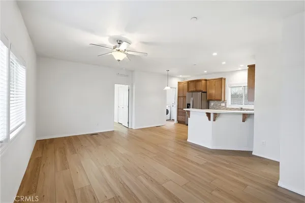 a large kitchen with stainless steel appliances granite countertop a stove a sink and a microwave