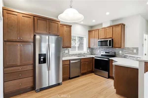 a view of kitchen with wooden floor and window