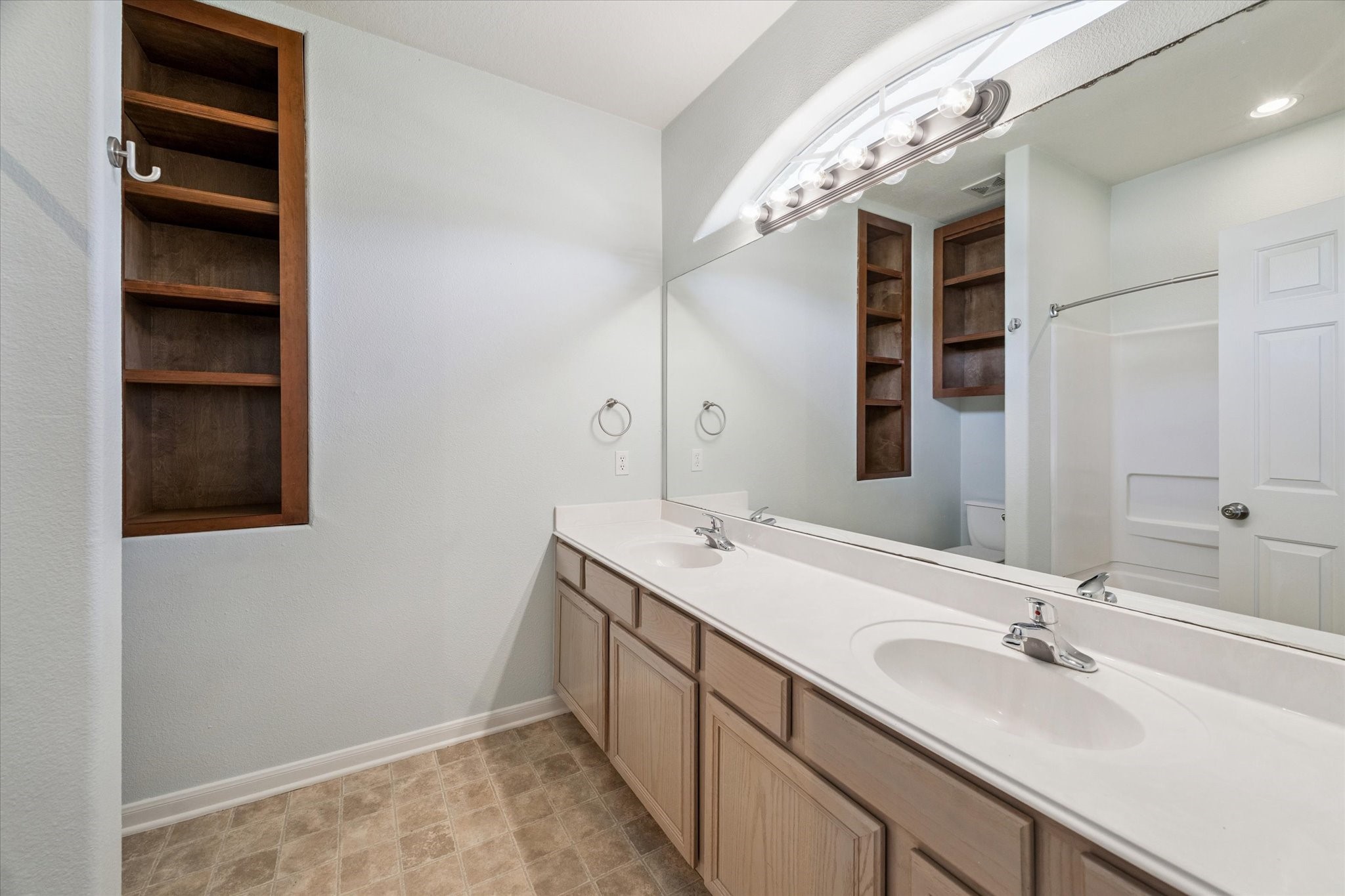 8 Pineway Conroe, TX 77304 - Photo 12 of 20 a bathroom with a double vanity sink and a mirror
