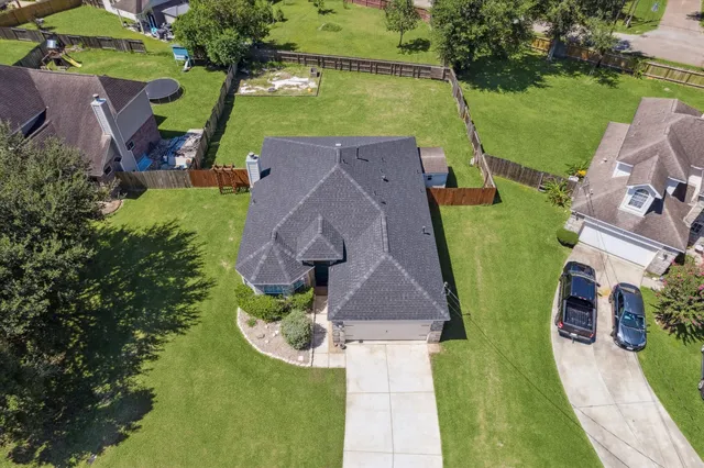 an aerial view of a house with garden space and street view