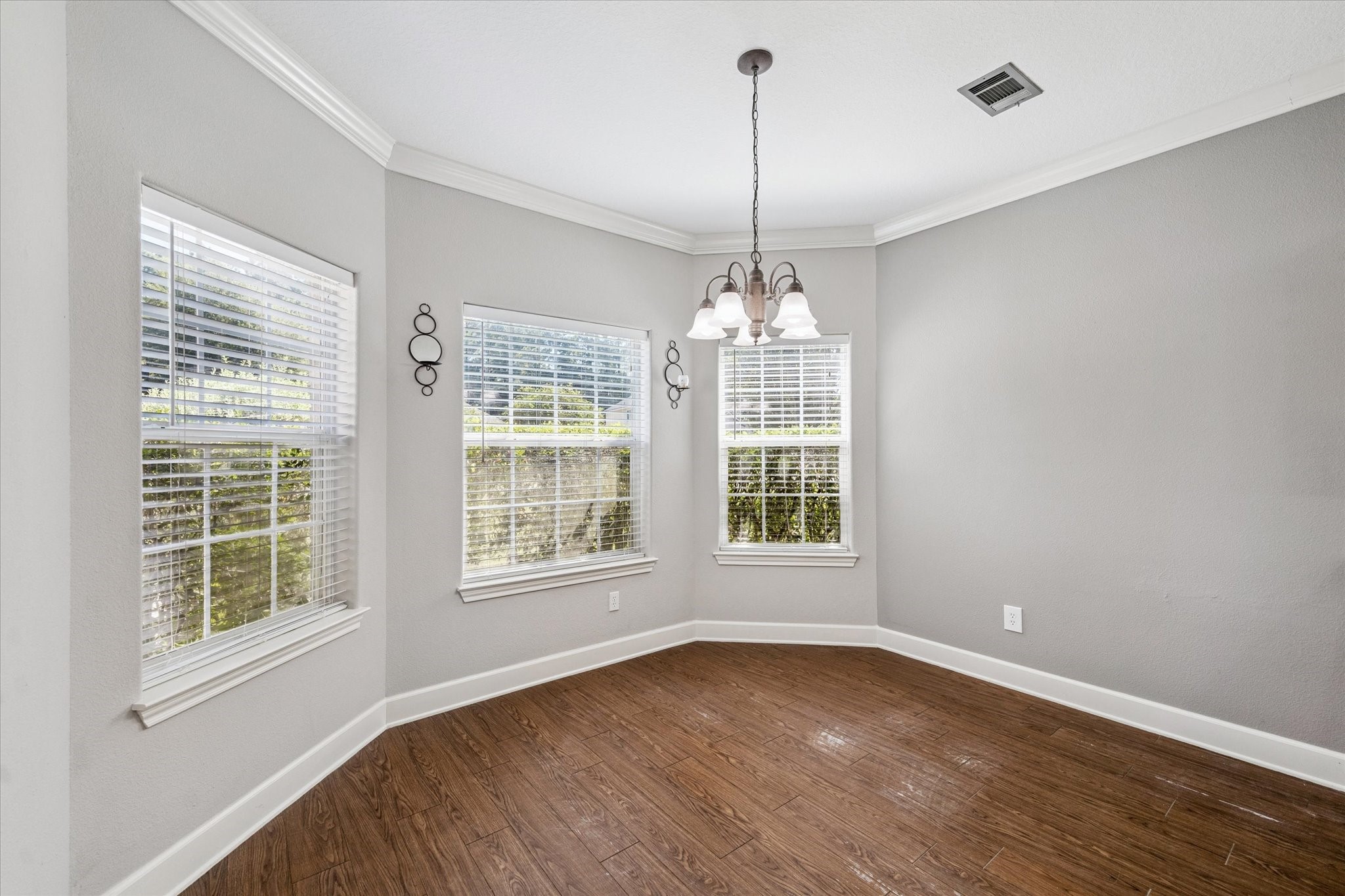 8 Pineway Conroe, TX 77304 - Photo 5 of 20 a view of an empty room with a window and wooden floor