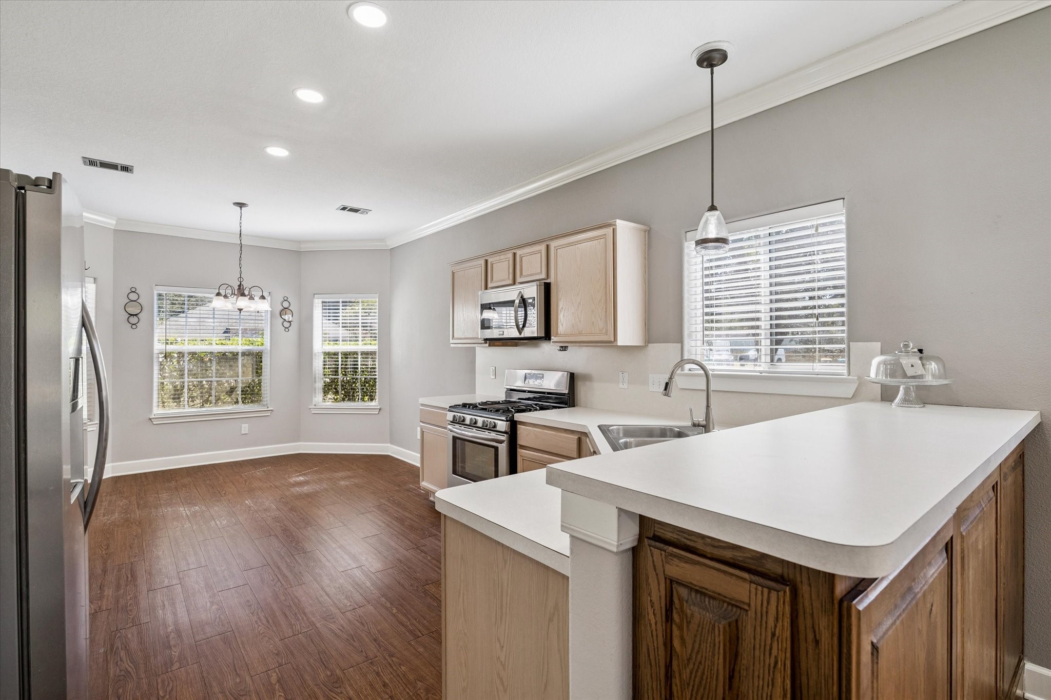 8 Pineway Conroe, TX 77304 - Photo 6 of 20 a kitchen with stainless steel appliances granite countertop a sink stove and refrigerator