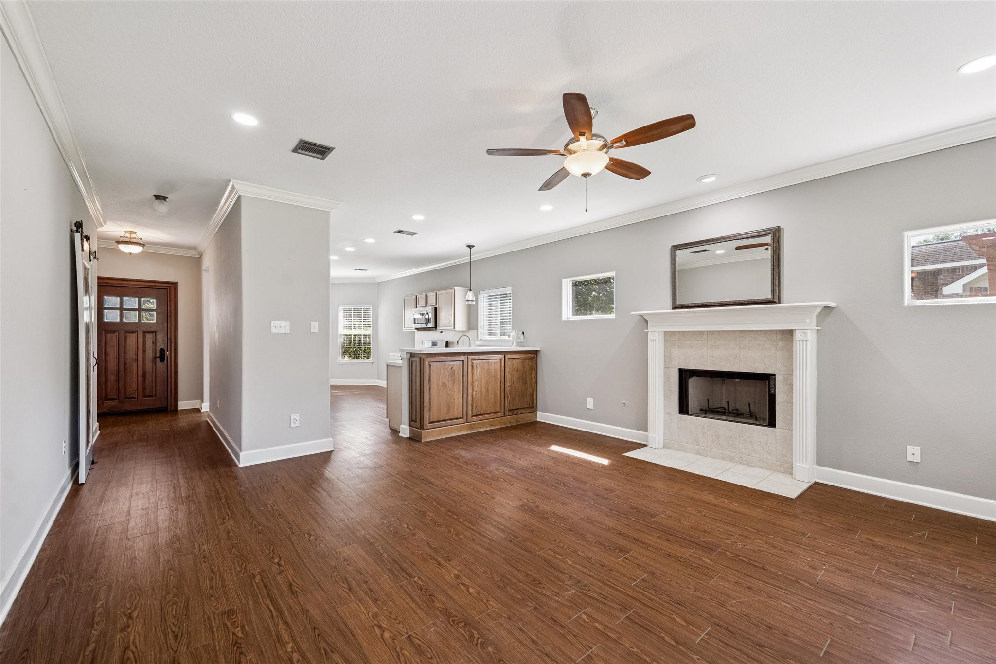 8 Pineway Conroe, TX 77304 - Photo 7 of 20 an empty room with wooden floor fireplace and windows