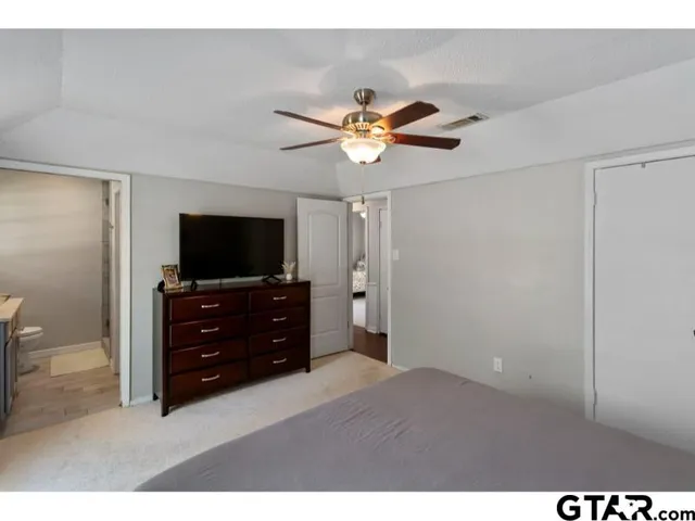 a bedroom with a bed and a flat screen tv