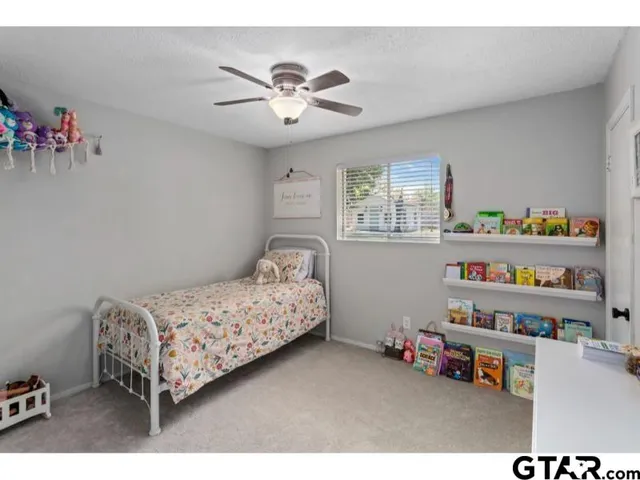 a bedroom with bed and a chandelier