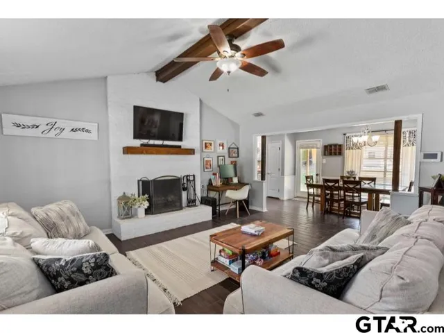 a living room with furniture and a fireplace