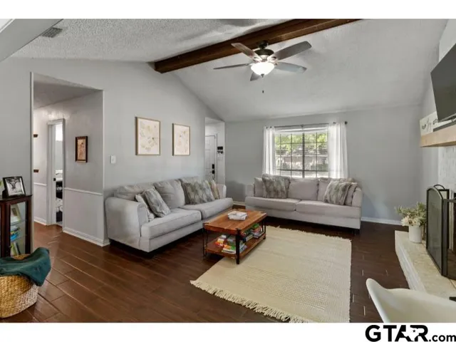 a living room with furniture and a chandelier