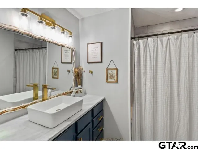 a bathroom with a sink vanity and a mirror