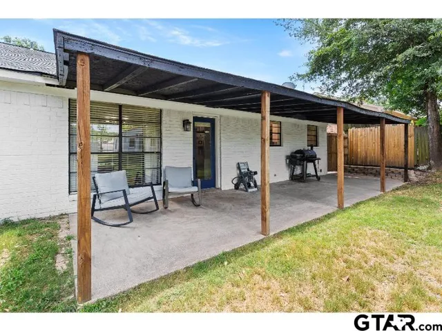 a view of a backyard with a patio