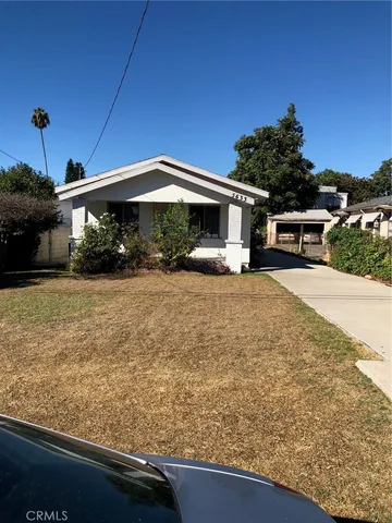 a view of a house with backyard porch and sitting area