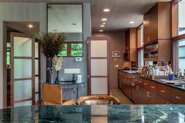 a kitchen with stainless steel appliances kitchen island granite countertop a refrigerator a stove and a sink