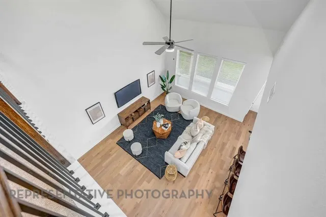 a living room with furniture and floor to ceiling window