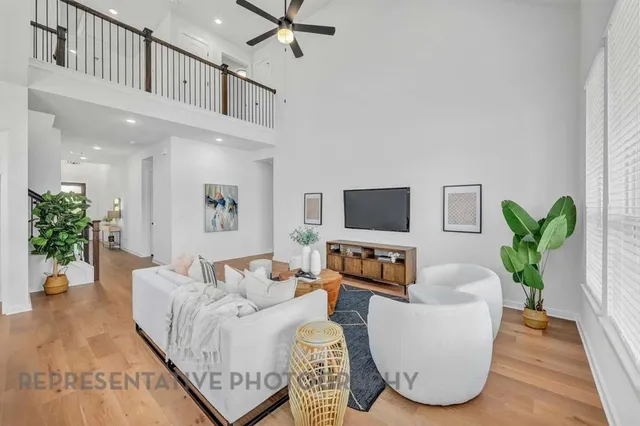 a living room with furniture flower pot and a flat screen tv