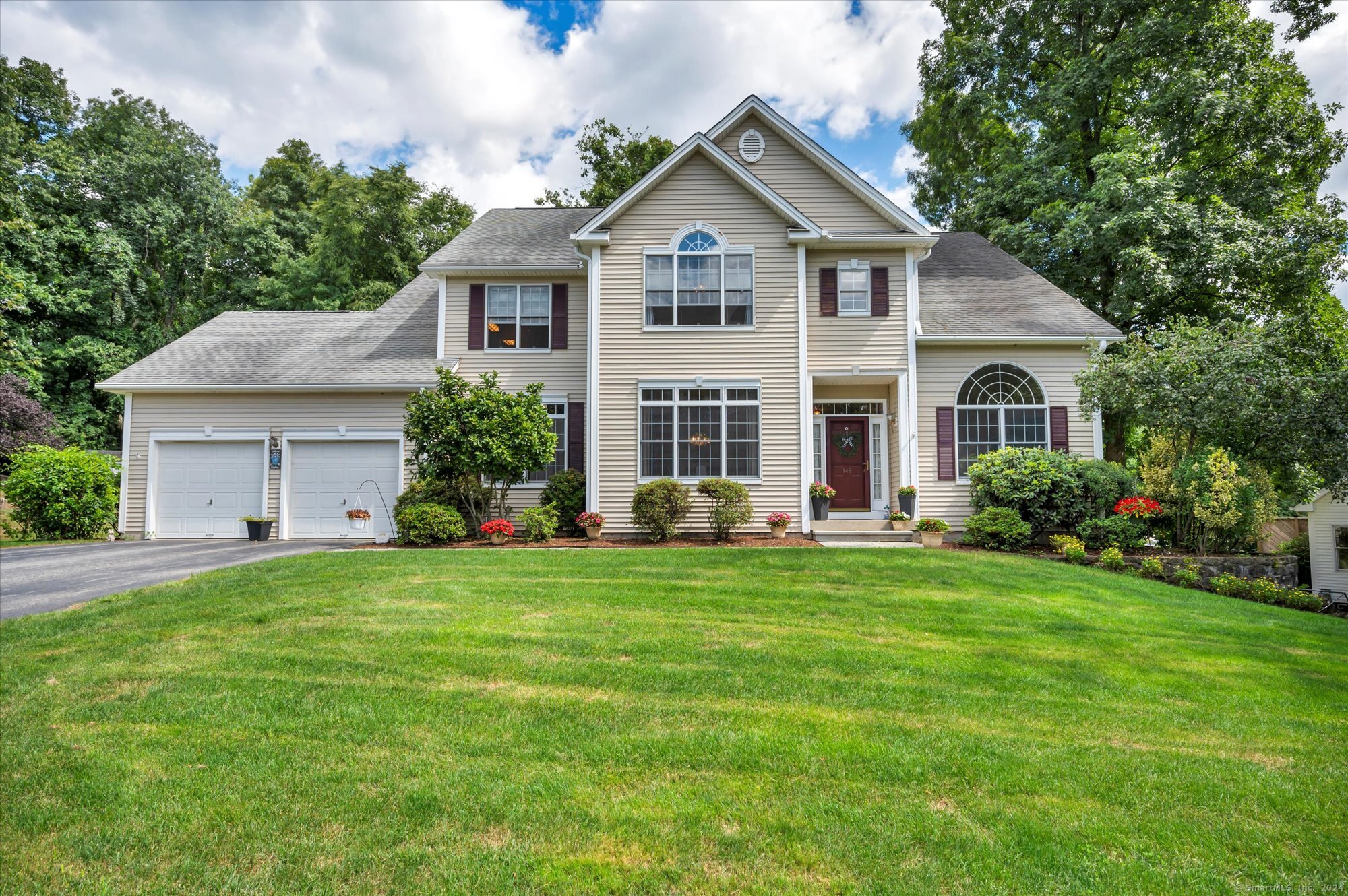 148 Centennial Drive Milford, CT 06461 - Photo 1 of 1 a front view of a house with a yard and garage