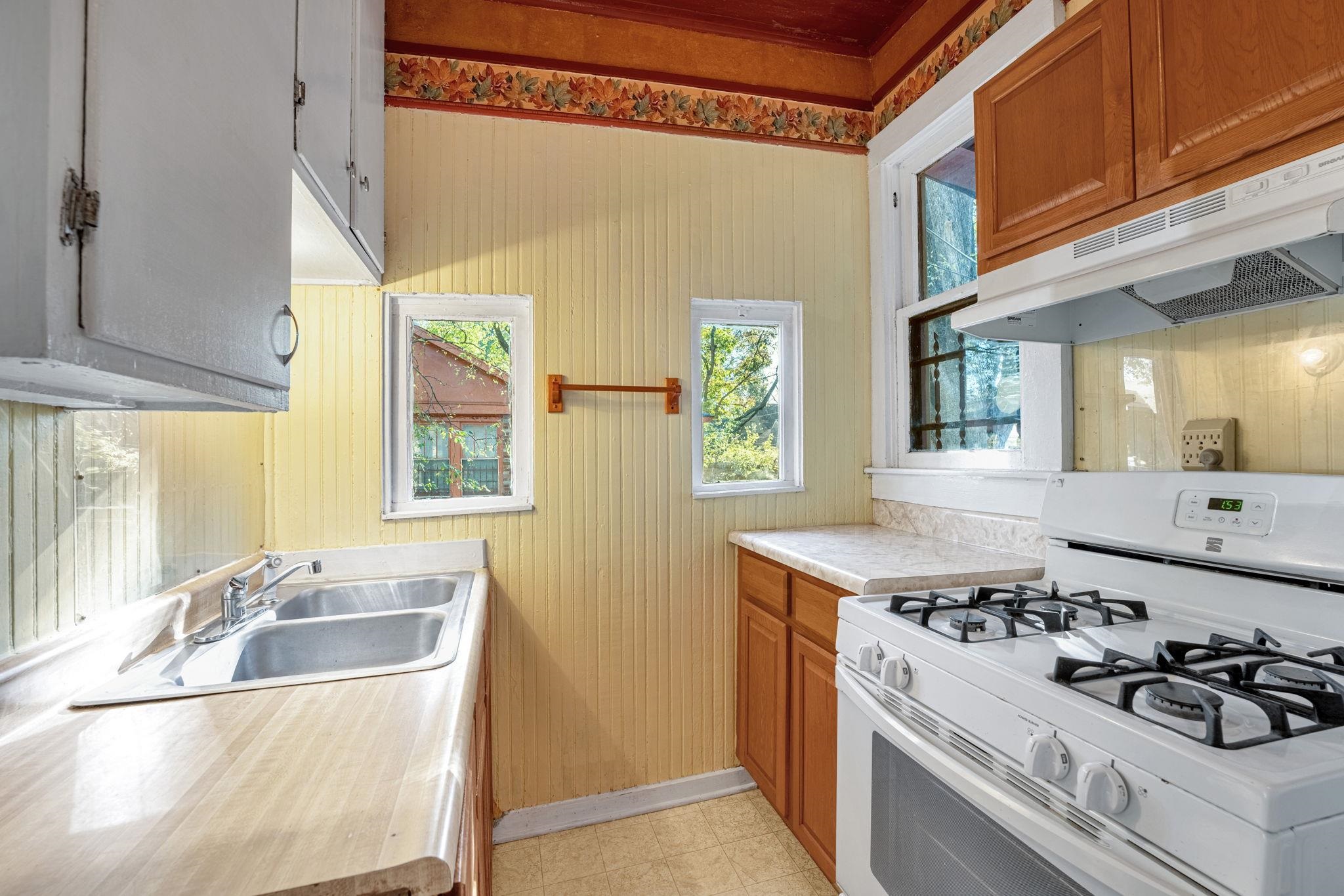 1033 Bruce Street Memphis, TN 38104 - Photo 12 of 19 a kitchen with a stove a sink and a refrigerator