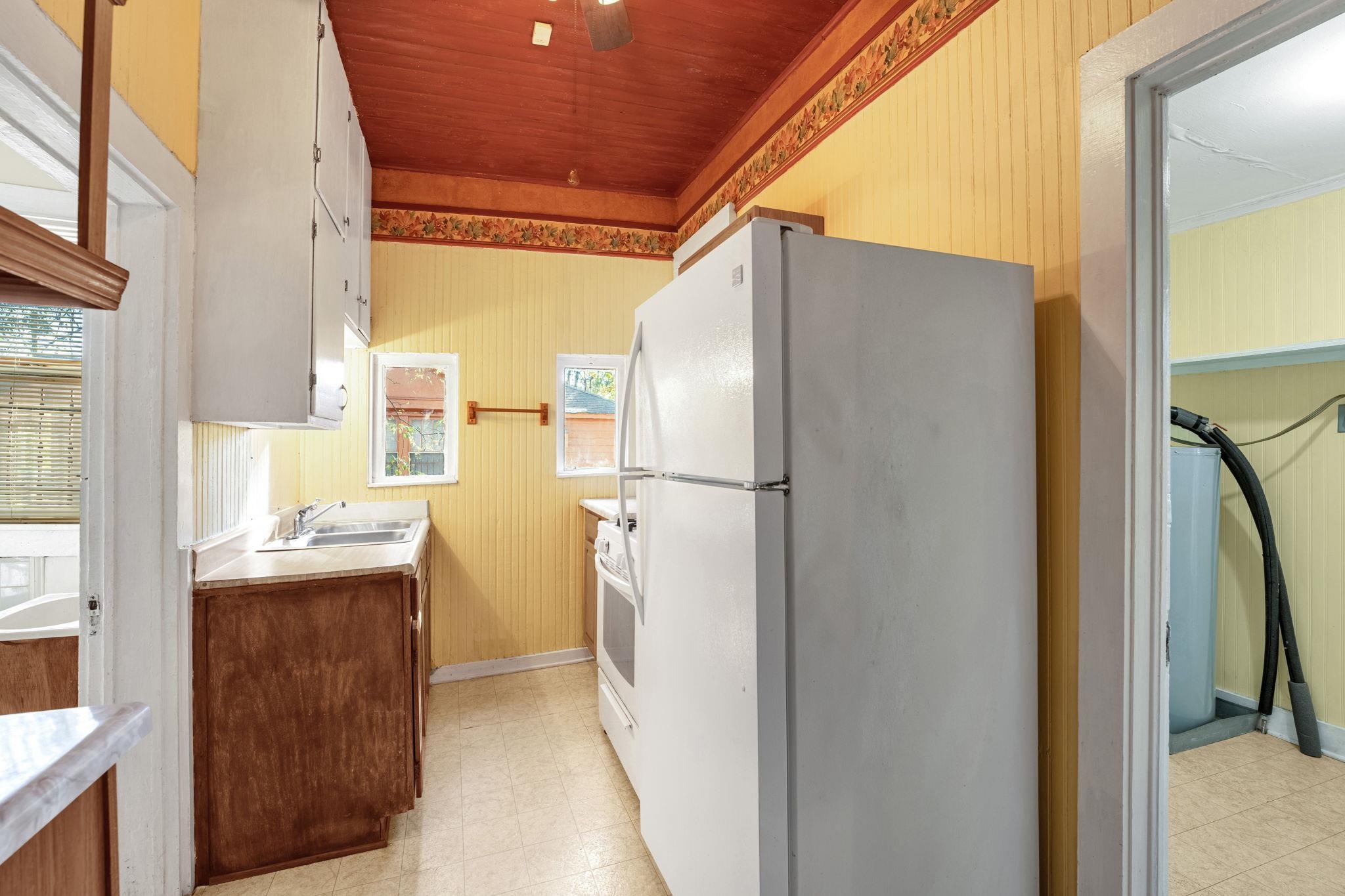 1033 Bruce Street Memphis, TN 38104 - Photo 13 of 19 a kitchen with a refrigerator and a stove