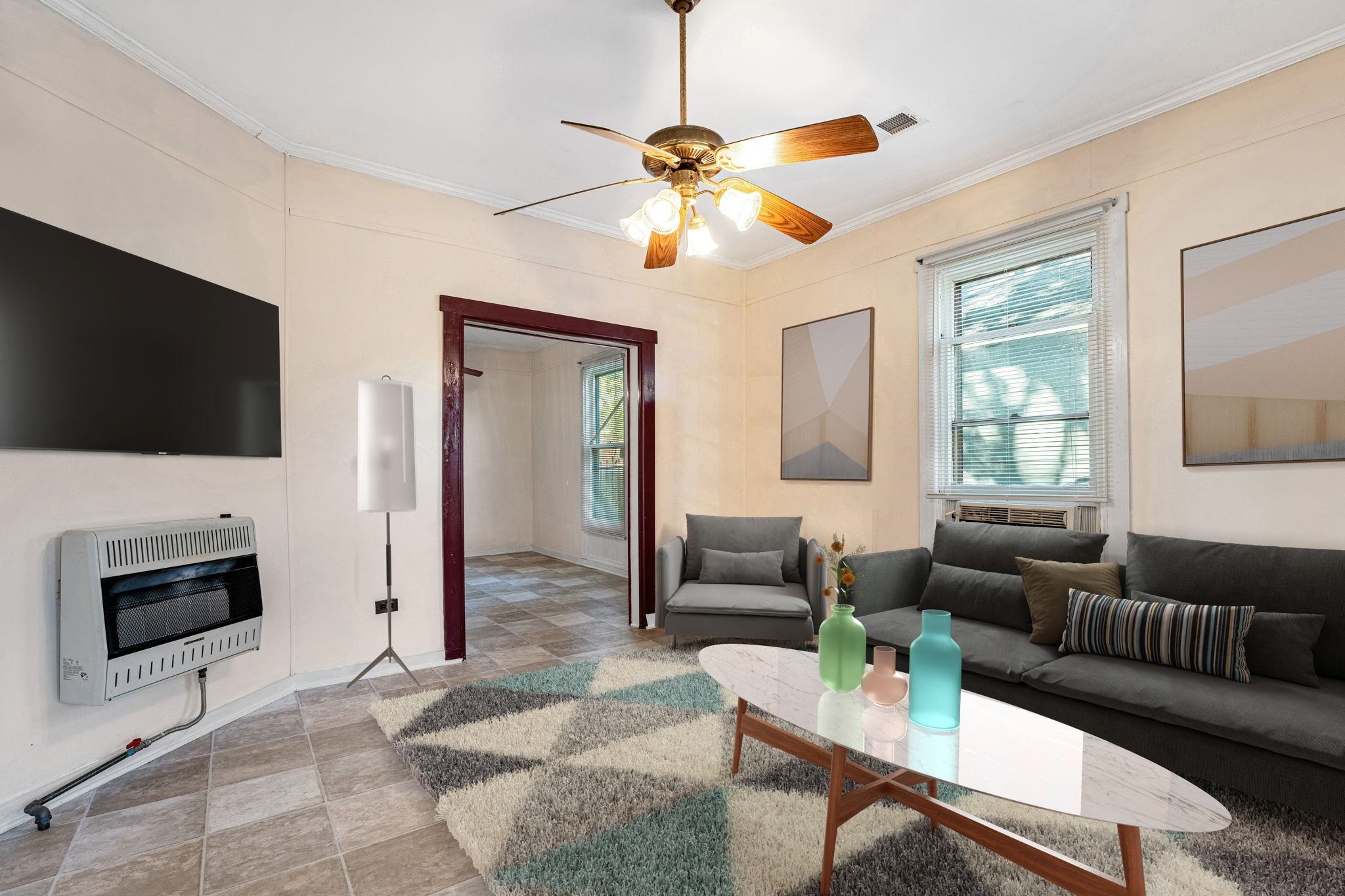 1033 Bruce Street Memphis, TN 38104 - Photo 2 of 19 a living room with furniture a flat screen tv and a window