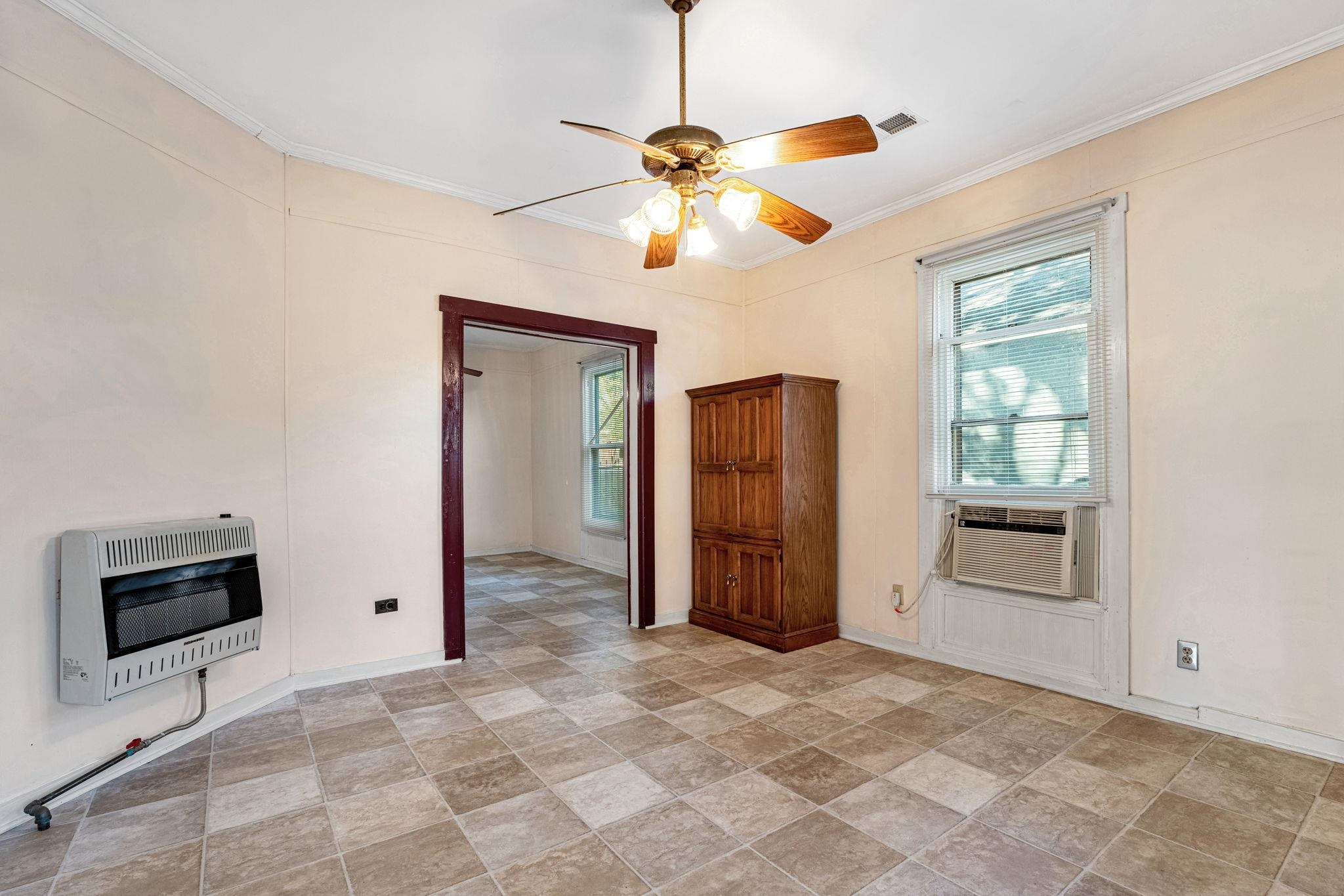 1033 Bruce Street Memphis, TN 38104 - Photo 4 of 19 a view of a livingroom with a chandelier fan and a window