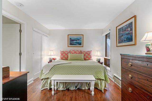 a bedroom with a bed and furniture with wooden floor