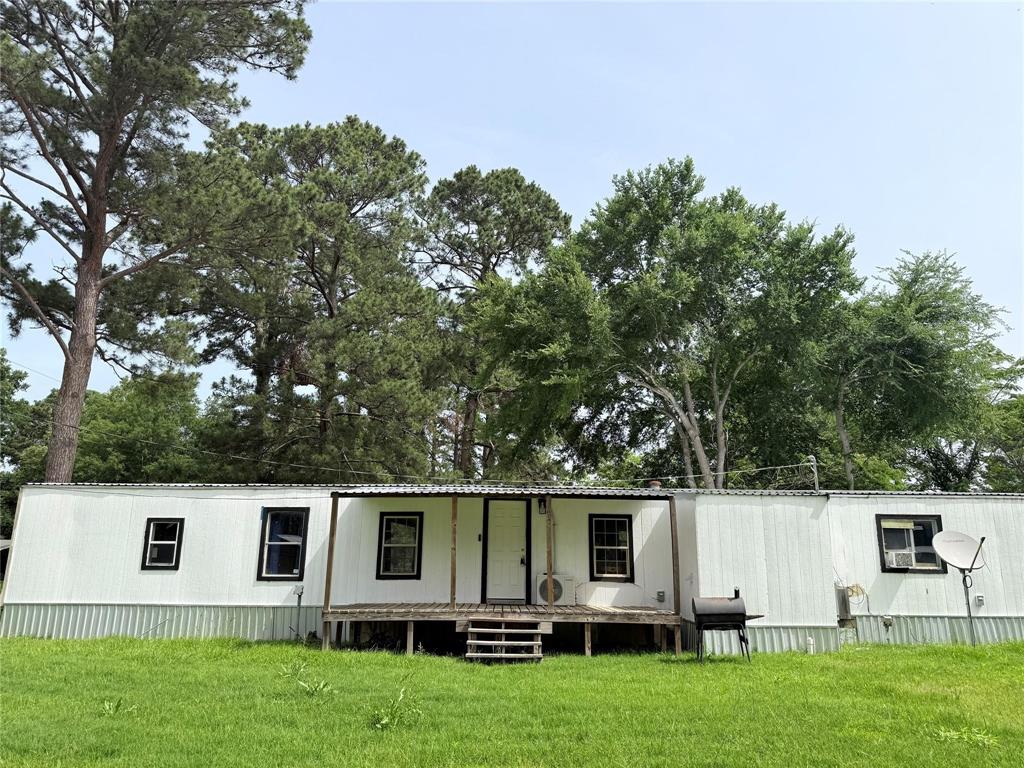 a view of house with backyard space and garden