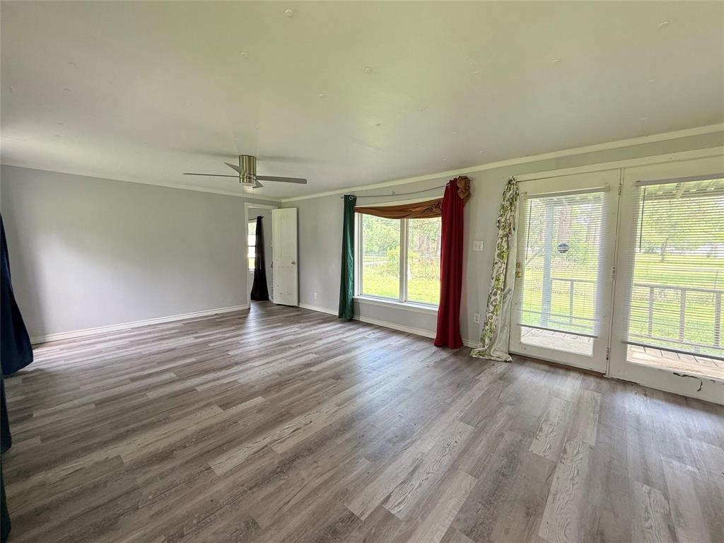 7729 Cutter Drive Frankston, TX 75763 - Photo 25 of 32 an empty room with wooden floor and windows