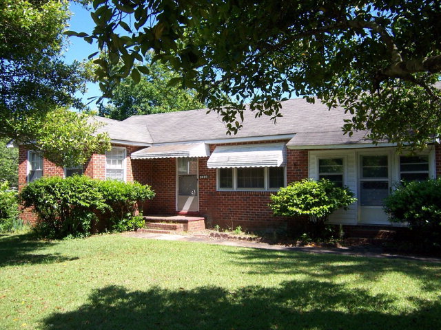a front view of house with yard and green space