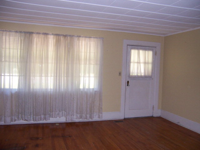 3439 Millerfield Road Macon, GA 31211 - Photo 11 of 15 an empty room with wooden floor and a window