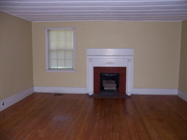 3439 Millerfield Road Macon, GA 31211 - Photo 5 of 15 a view of an empty room with wooden floor and a window
