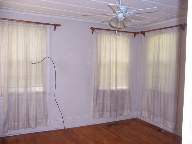 3439 Millerfield Road Macon, GA 31211 - Photo 7 of 15 an empty room with wooden floor and windows