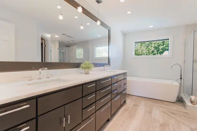 a bathroom with a tub sink and a mirror