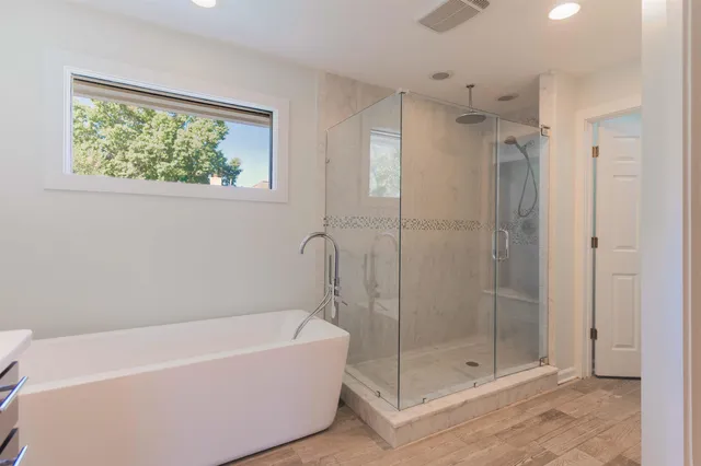 a bathroom with a bathtub and shower