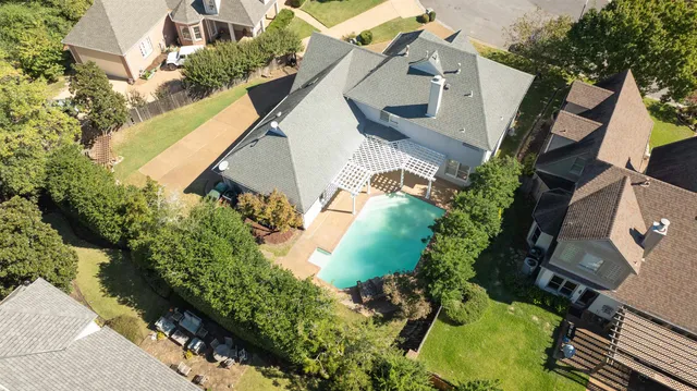 an aerial view of a house with a yard and potted plants