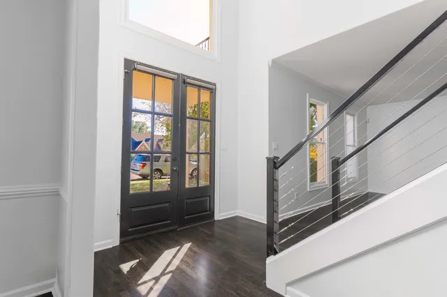 a view of an entryway with wooden floor and door