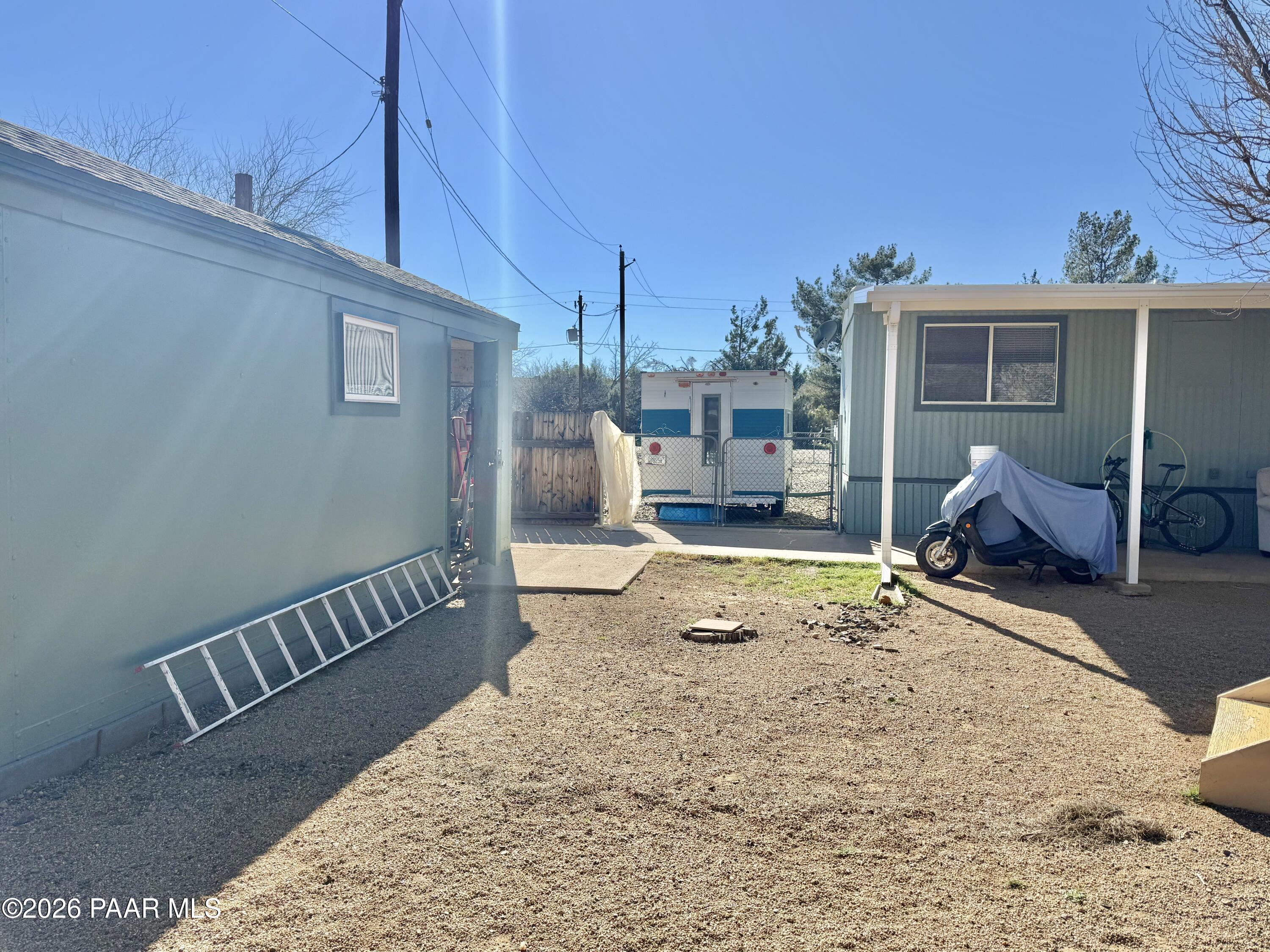 20817 East Butterfield Road Mayer, AZ 86333 - Photo 11 of 47 a view of a backyard with a wooden fence