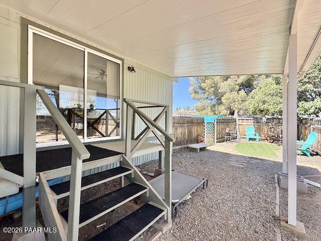 20817 East Butterfield Road Mayer, AZ 86333 - Photo 15 of 47 a view of an empty room with wooden floor and a large window