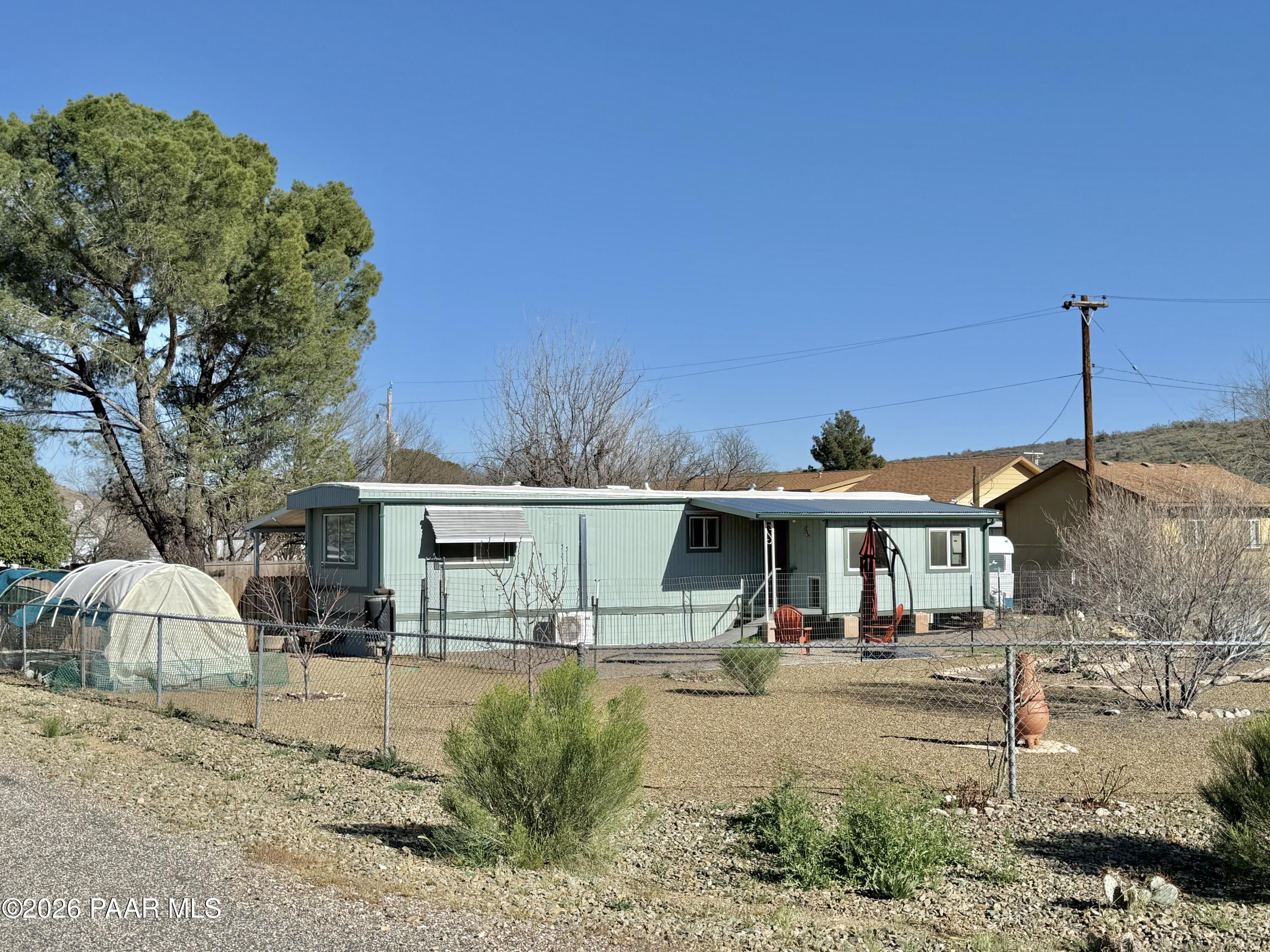 20817 East Butterfield Road Mayer, AZ 86333 - Photo 20 of 24 a view of a town with large trees and a barn
